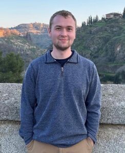 Kane Olesen standing outside with hands in pockets