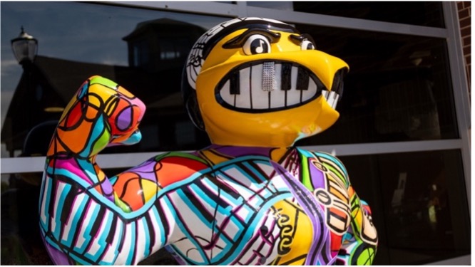 "The Musical World of Imagination" Herky shows off his bedazzled grill featured in his mouth made to look like piano keys.